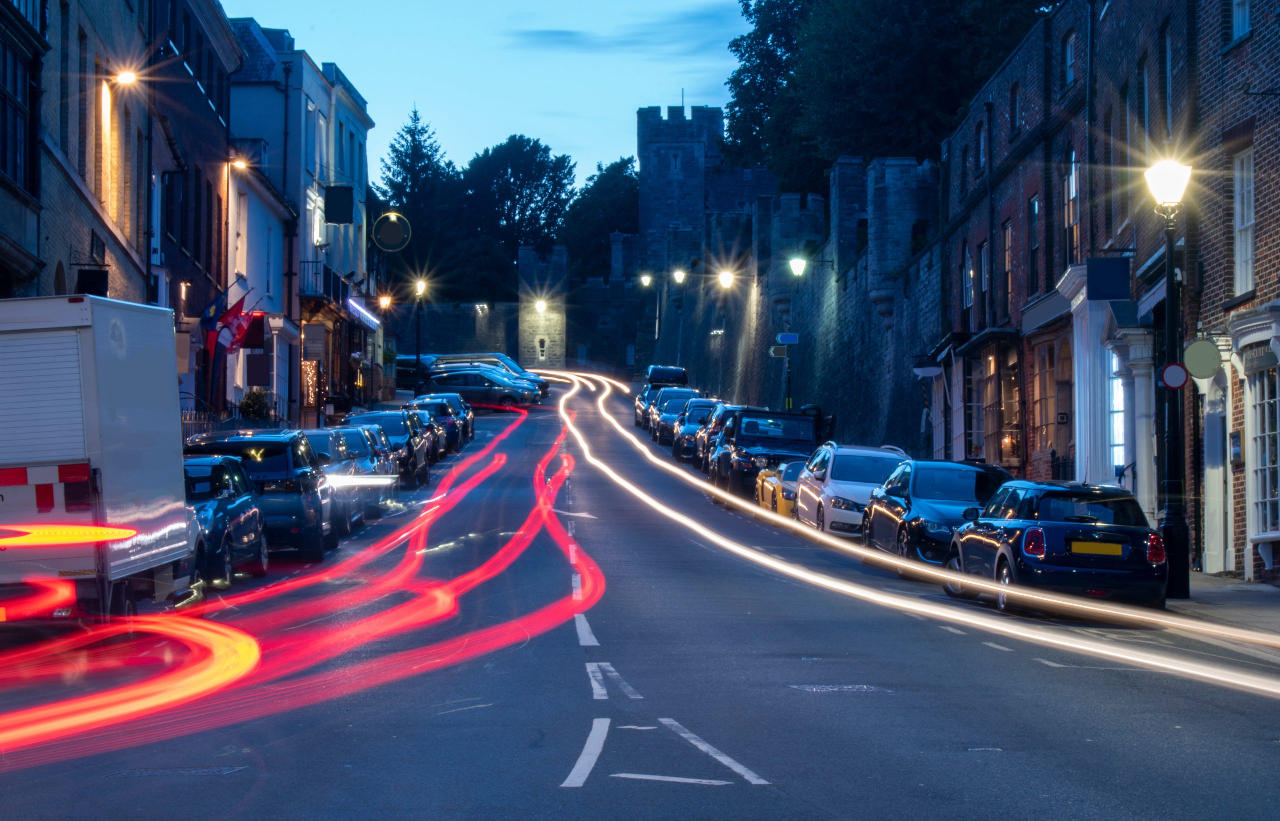 Arundel High Street, England, night photo with car light trails. By Geoffrey (Adobe Stock)